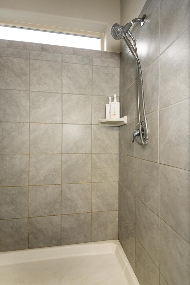 bathroom with tiled shower