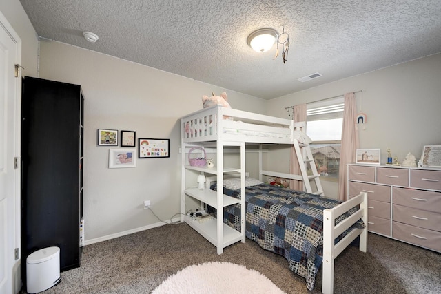 carpeted bedroom featuring a textured ceiling