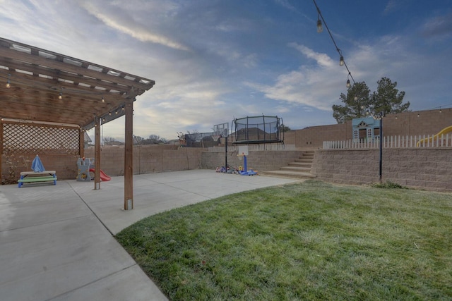 view of yard with a pergola, a trampoline, and a patio area