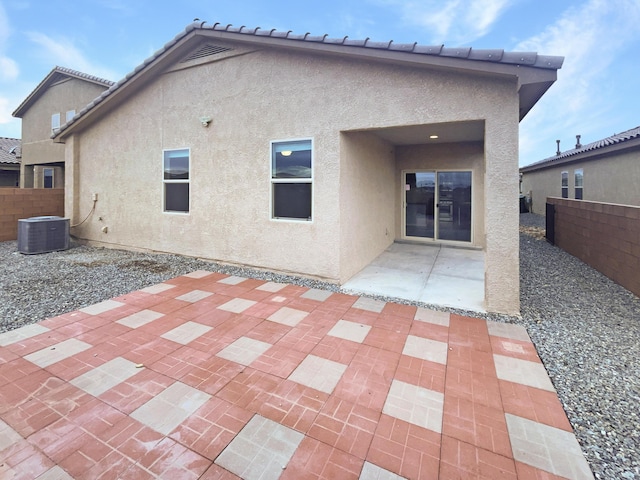 rear view of property with a patio and cooling unit