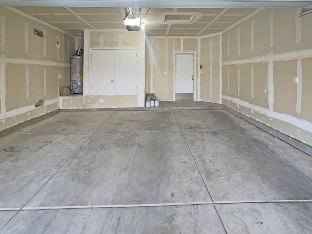 garage with water heater and a garage door opener