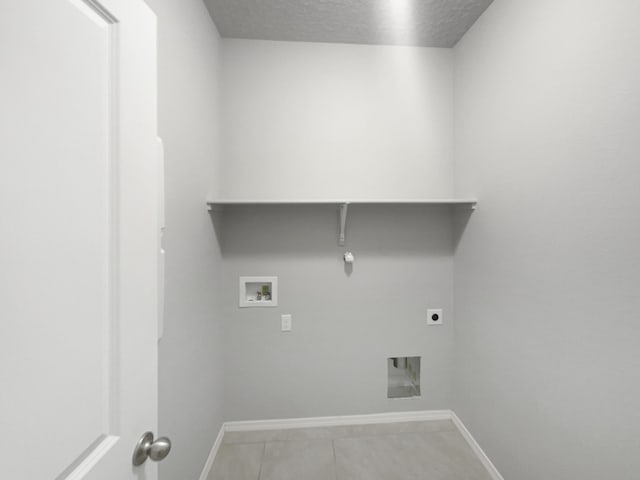 laundry room featuring electric dryer hookup, hookup for a gas dryer, hookup for a washing machine, a textured ceiling, and light tile patterned flooring