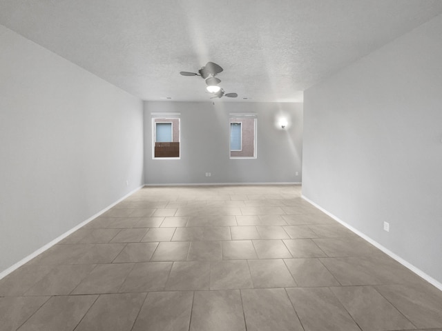 tiled spare room featuring ceiling fan and a textured ceiling