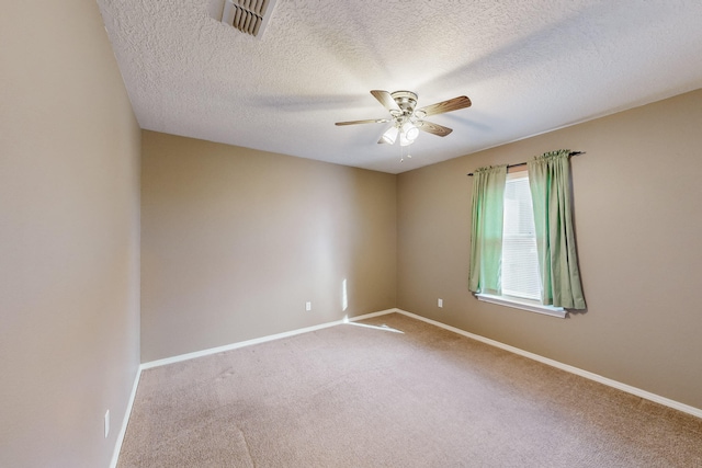 empty room with carpet flooring, a textured ceiling, and ceiling fan