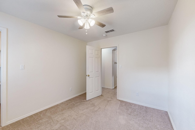 unfurnished room featuring light carpet and ceiling fan