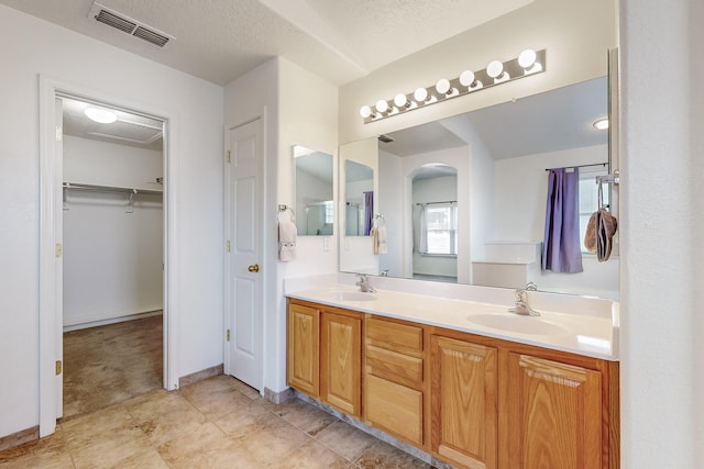 bathroom featuring vanity and a textured ceiling