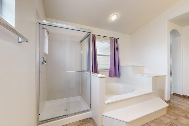 bathroom featuring plus walk in shower and lofted ceiling