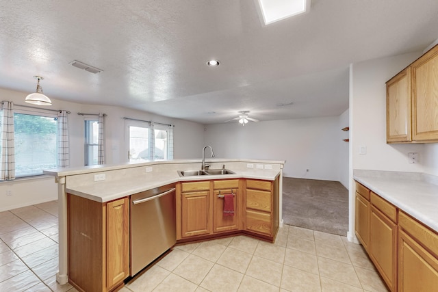 kitchen featuring sink, stainless steel dishwasher, kitchen peninsula, a textured ceiling, and decorative light fixtures