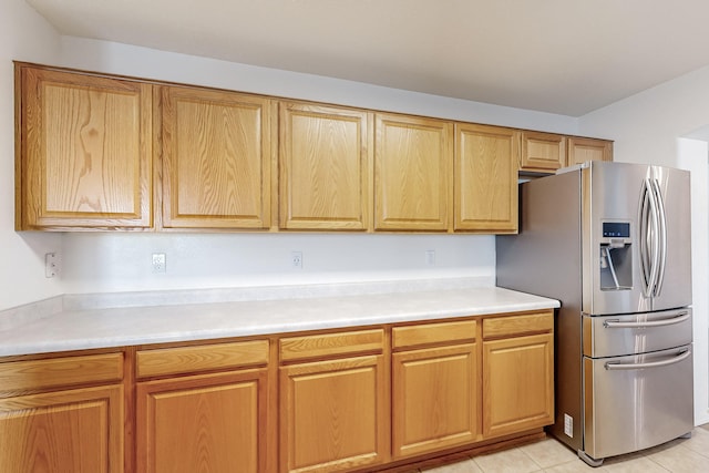 kitchen with stainless steel refrigerator with ice dispenser and light tile patterned floors