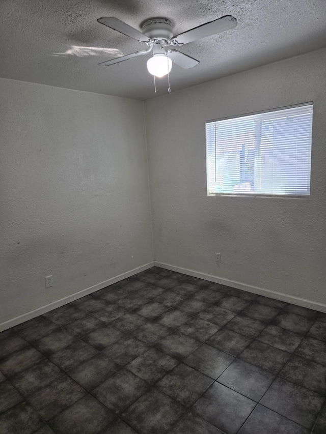 empty room featuring a textured ceiling and ceiling fan