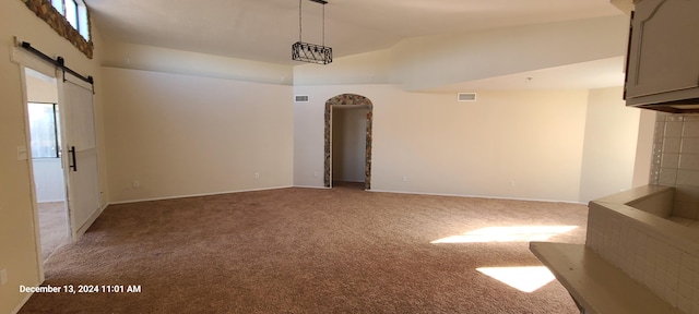 carpeted spare room featuring vaulted ceiling