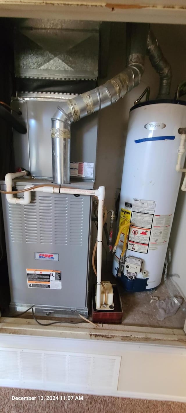 utility room featuring water heater