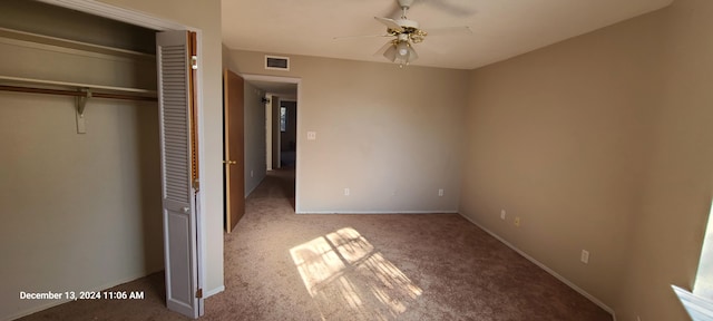 unfurnished bedroom featuring carpet flooring, a closet, and ceiling fan