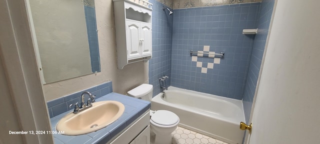 full bathroom with vanity, toilet, and tiled shower / bath