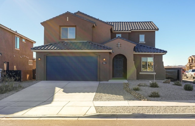 mediterranean / spanish-style home with a garage