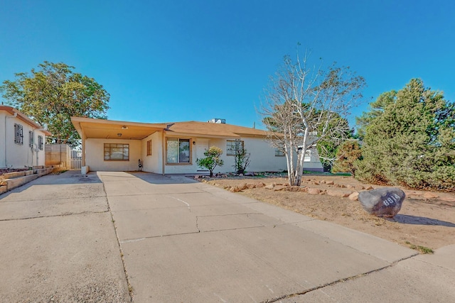 ranch-style house with a carport