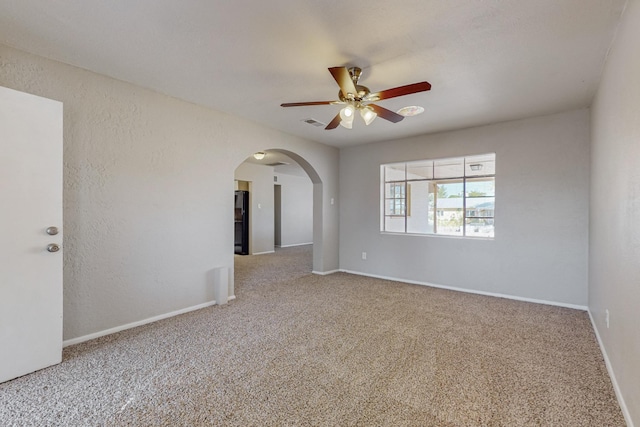 carpeted spare room with ceiling fan