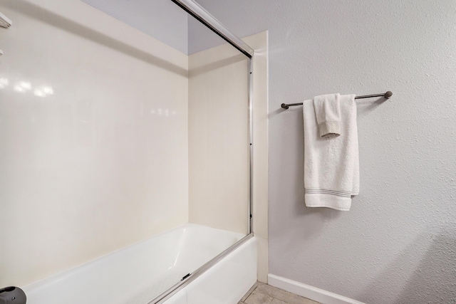 bathroom featuring tile patterned flooring and shower / bathing tub combination