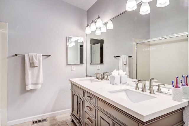 bathroom with tile patterned flooring, vanity, and an enclosed shower