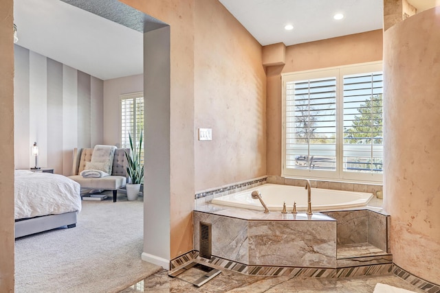 bathroom featuring a relaxing tiled tub