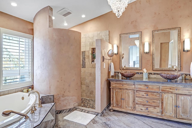 bathroom featuring vanity, lofted ceiling, shower with separate bathtub, and an inviting chandelier