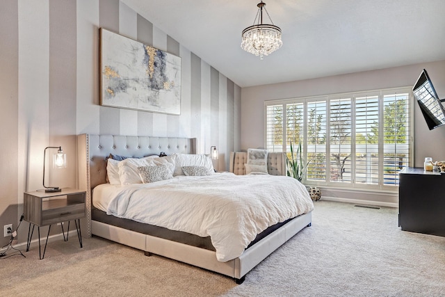 carpeted bedroom with a chandelier and vaulted ceiling