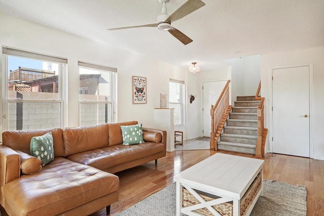 living room featuring light hardwood / wood-style flooring and ceiling fan