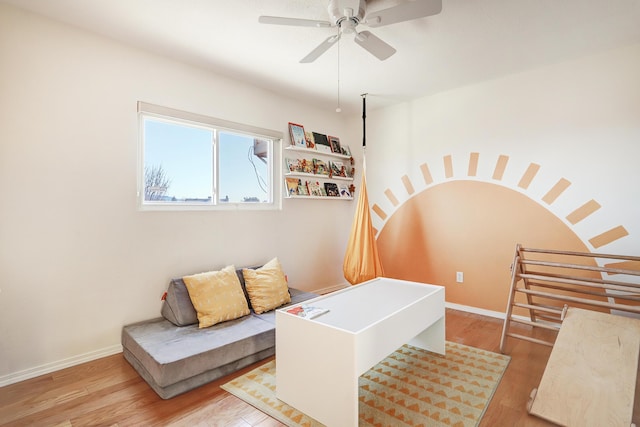 sitting room with ceiling fan and light wood-type flooring