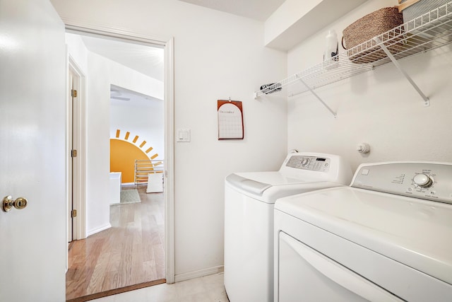 washroom featuring light wood-type flooring and washing machine and clothes dryer