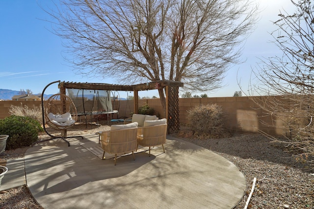 view of patio / terrace with a mountain view, an outdoor hangout area, and a trampoline