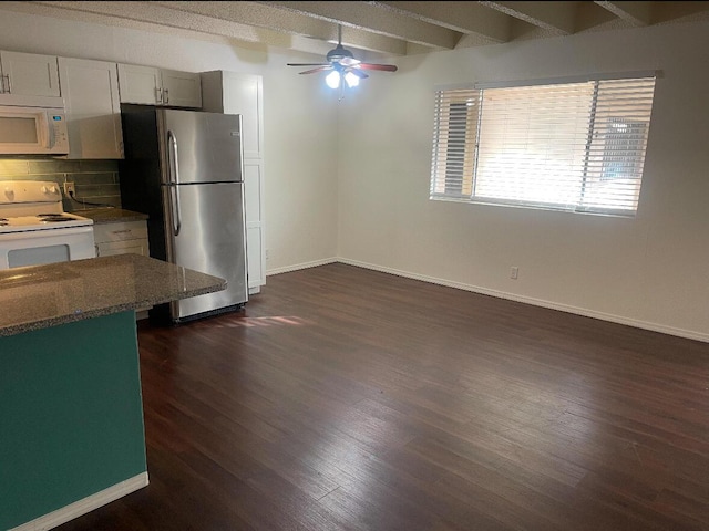 kitchen with white appliances, white cabinets, decorative backsplash, beam ceiling, and dark hardwood / wood-style flooring