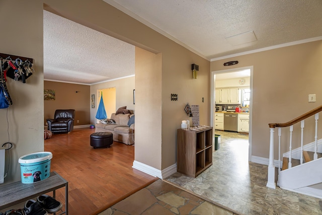 hallway featuring hardwood / wood-style floors, a textured ceiling, and ornamental molding