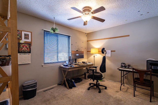 home office with ceiling fan, carpet, and a textured ceiling