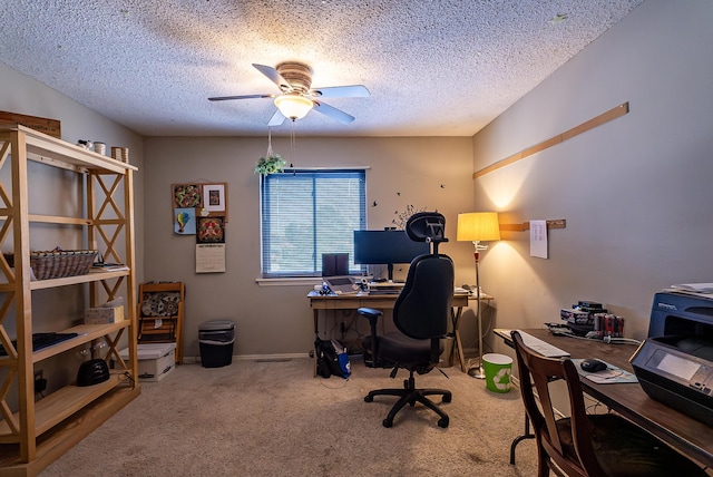 office space with ceiling fan, light colored carpet, and a textured ceiling