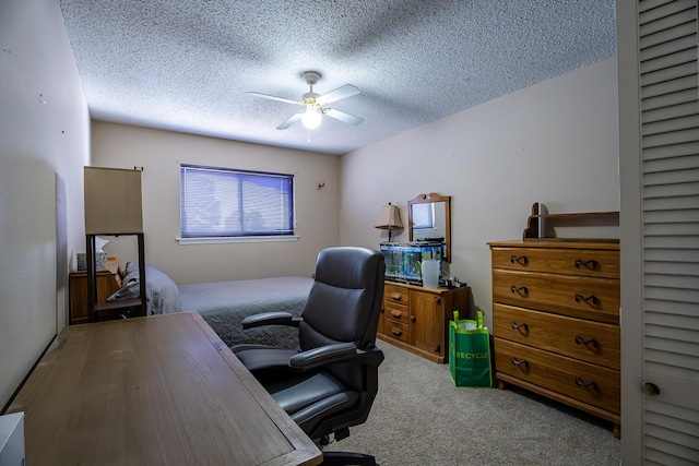 office featuring ceiling fan, light colored carpet, and a textured ceiling