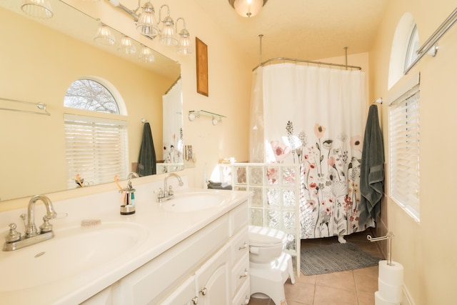 bathroom featuring tile patterned floors, vanity, and toilet