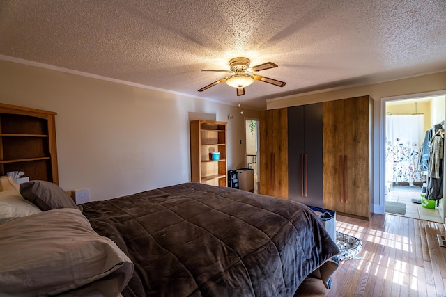 bedroom featuring ceiling fan, crown molding, light hardwood / wood-style floors, a textured ceiling, and access to outside