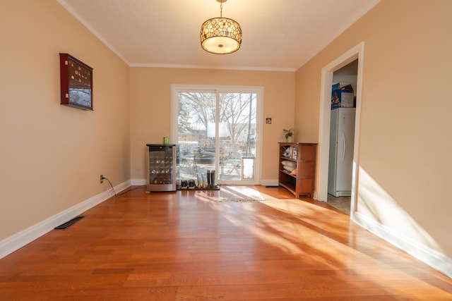 interior space featuring hardwood / wood-style floors and ornamental molding