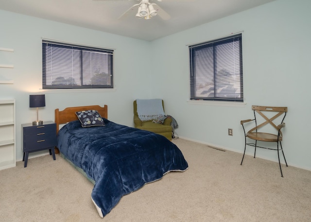 carpeted bedroom featuring ceiling fan