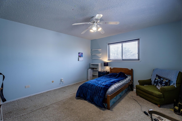 bedroom featuring a textured ceiling, ceiling fan, and light carpet