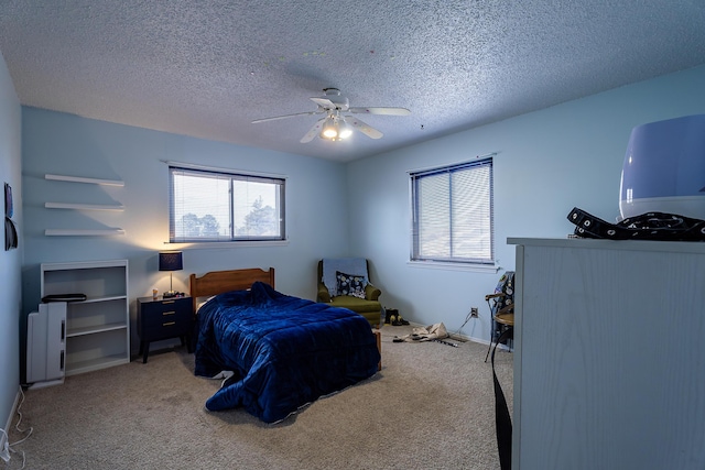 carpeted bedroom with a textured ceiling and ceiling fan