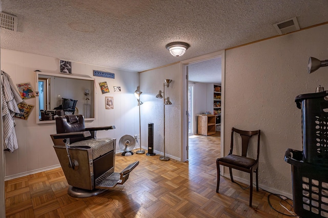 office space featuring a textured ceiling and parquet flooring