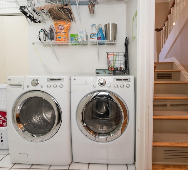 washroom featuring light tile patterned floors and separate washer and dryer