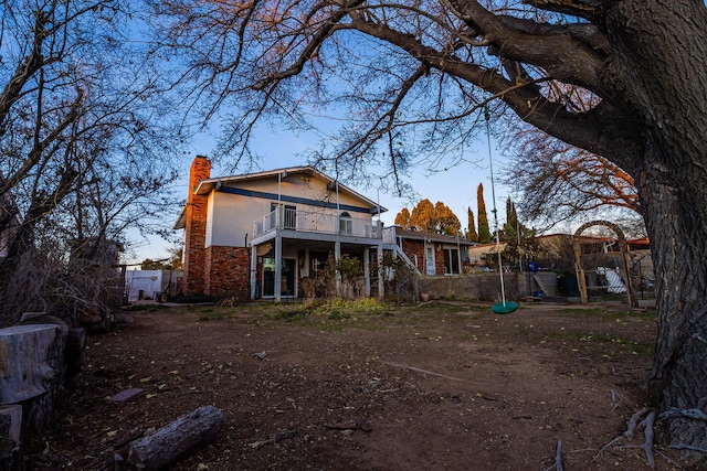 rear view of property with a balcony