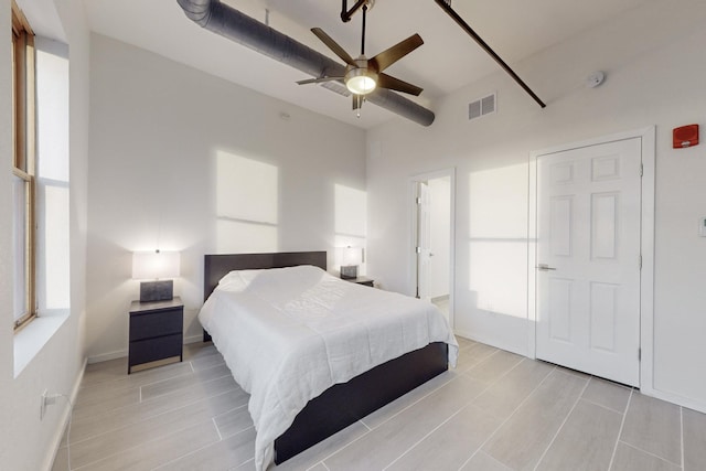 bedroom with ceiling fan and light wood-type flooring