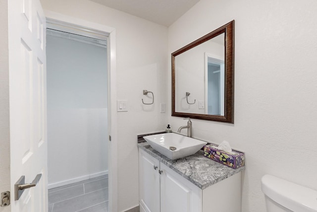 bathroom with tile patterned floors, vanity, and toilet