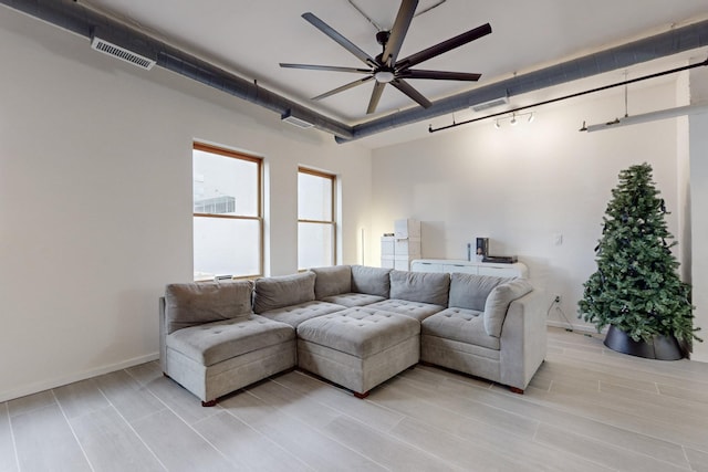 living room featuring ceiling fan and light hardwood / wood-style flooring