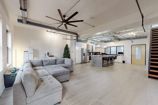 living room with ceiling fan and light hardwood / wood-style flooring