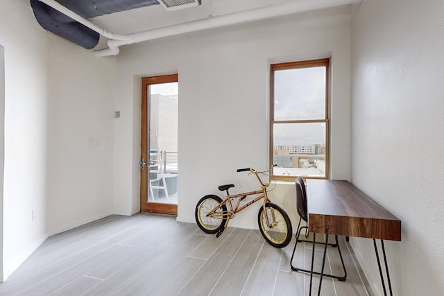 office featuring a healthy amount of sunlight and light hardwood / wood-style flooring