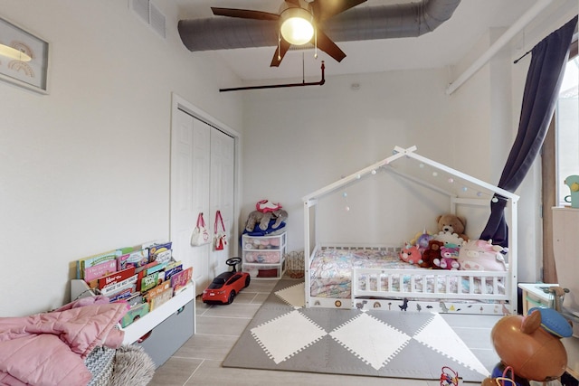 bedroom with a closet, ceiling fan, and light hardwood / wood-style flooring